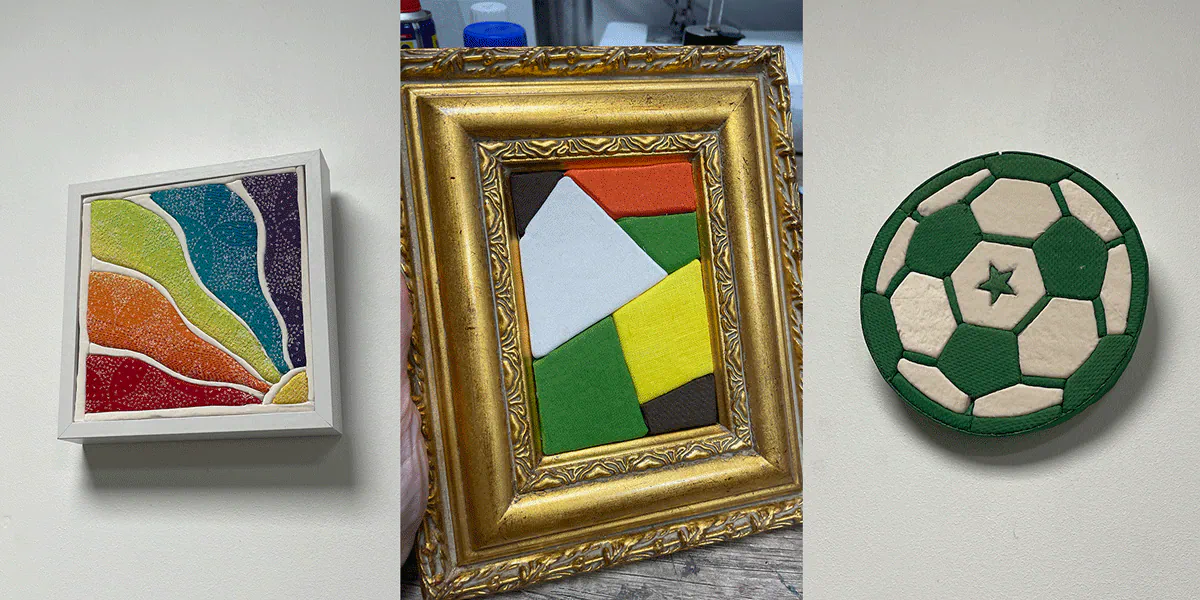 3 Kinusaiga artworks: pieces of fabric tucked into grooves cut in a board, forming a raised image.