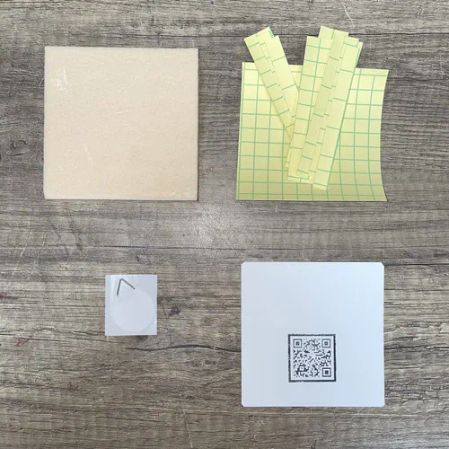 The base contents of the Kinusaiga Refill Kit: its support board, its adhesives and the cardboard backing with hanger.